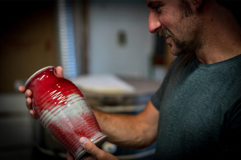 Small Business Websites Like Etsy concept ceramist holding finished vase